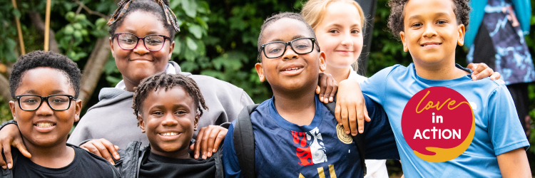 A group of kids standing together. A circular logo in the bottom right corner reads 'Love in ACTION'.